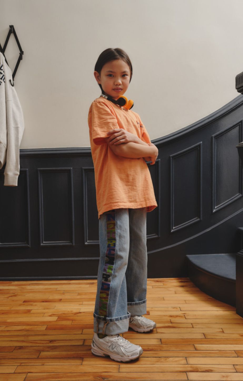 Girl standing in a hallway wearing new balance 740 sneakers